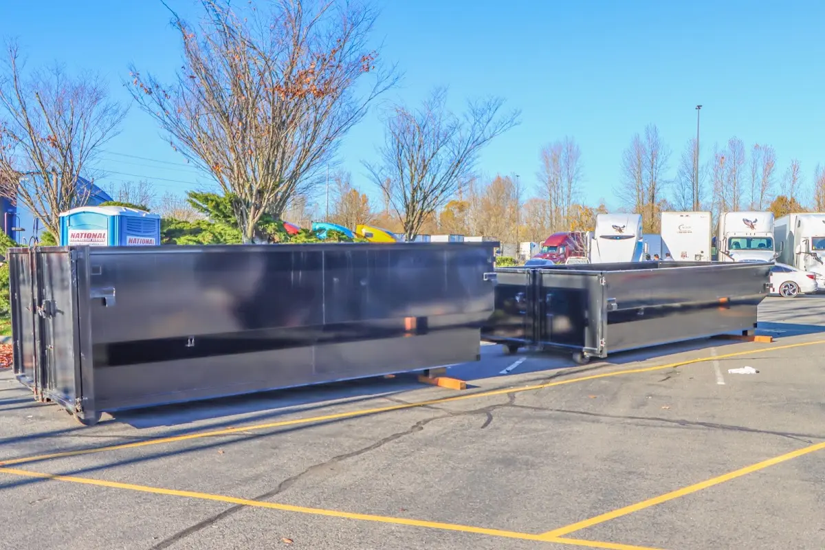 Professional dumpster rental service with roll-off container on residential driveway in Bothell East
